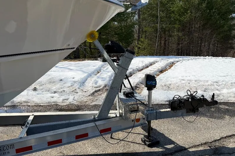 Slide: The Image of 2023 Boston Whaler 250 Outrage boat on trailer in snowy landscape. - 7