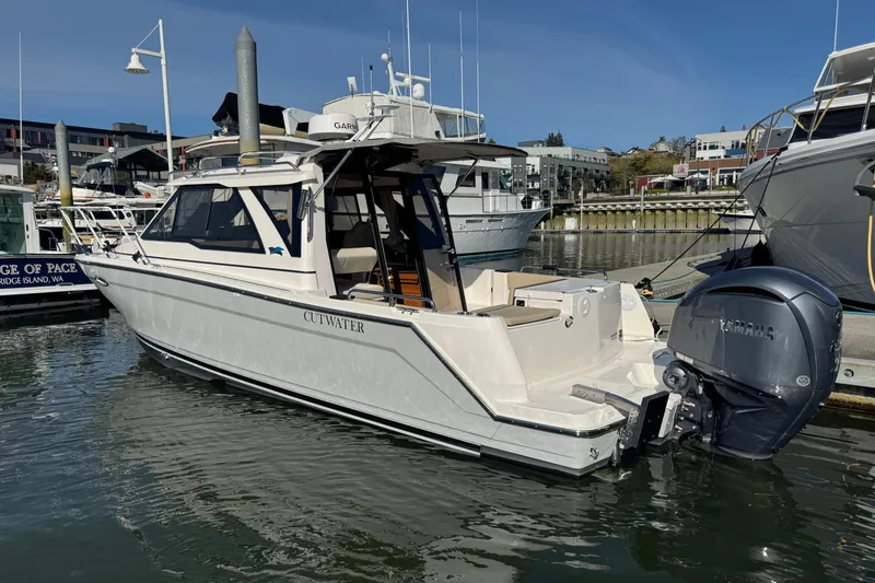 Slide: The Image of 2026 Cutwater C-248 Coupe boat docked at marina with Yamaha outboard motor. - 1