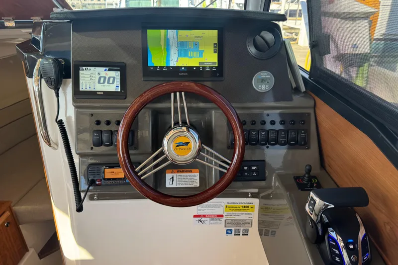 Slide: The Image of 2026 Cutwater C-248 Coupe dashboard with steering wheel, navigation screens, and controls. - 10