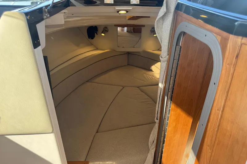 Slide: The Image of Interior cabin of 2026 Cutwater C-248 Coupe, featuring cozy seating and wooden accents. - 12