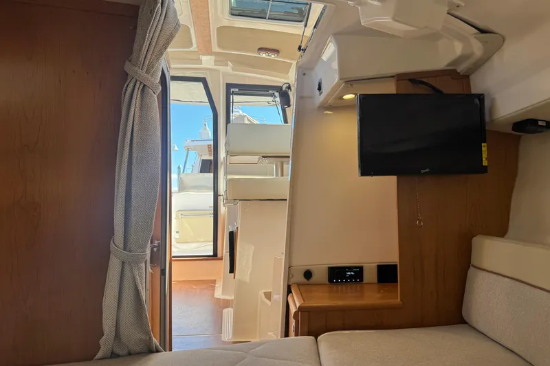 Slide: The Image of Interior view of 2026 Cutwater C-248 Coupe, featuring cozy seating and modern amenities. - 14