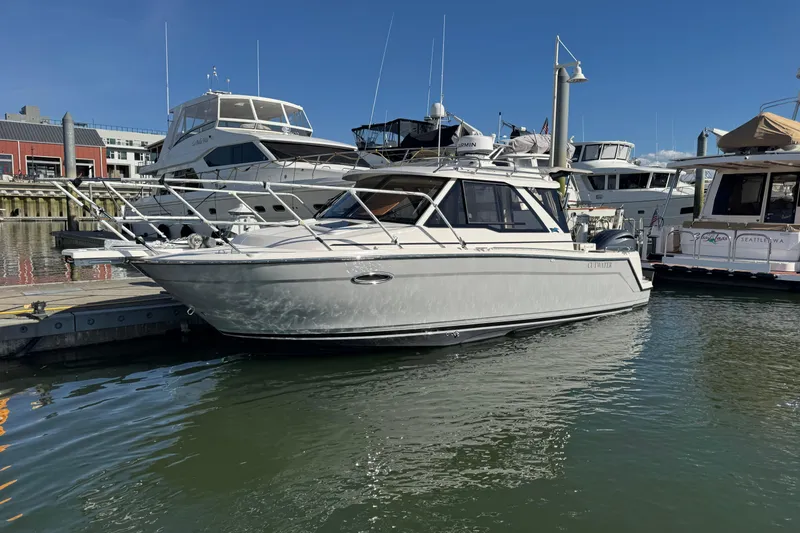 Slide: The Image of 2026 Cutwater C-248 Coupe docked at marina, surrounded by other boats. - 2