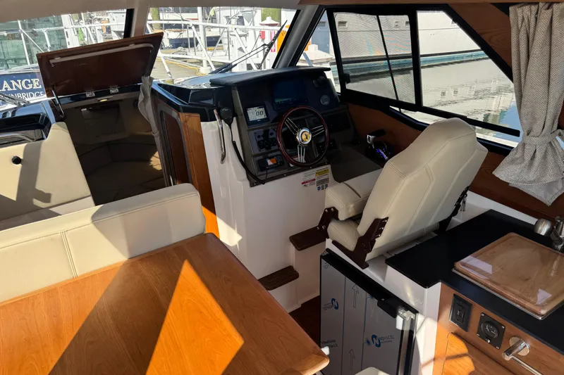 Slide: The Image of Interior of 2026 Cutwater C-248 Coupe boat, featuring helm, seating, and kitchenette. - 7