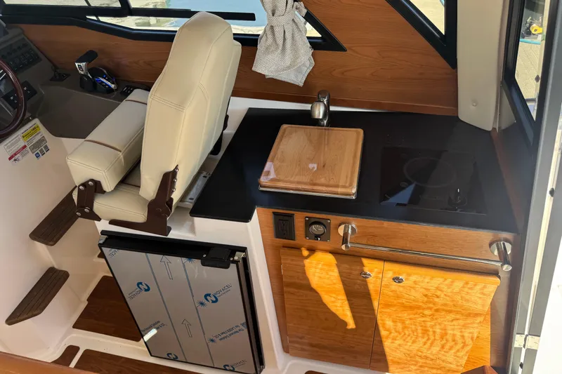 Slide: The Image of 2026 Cutwater C-248 Coupe interior with kitchenette and captain's chair. - 8