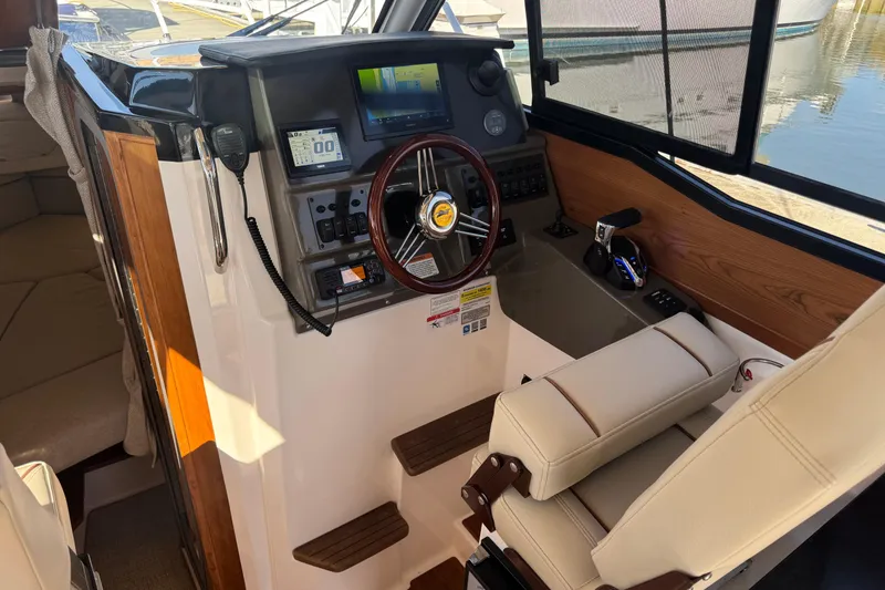 Slide: The Image of Interior cockpit of 2026 Cutwater C-248 Coupe, featuring modern controls and steering wheel. - 9