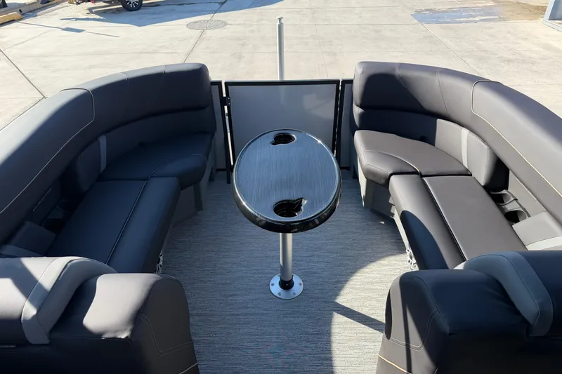 Slide: The Image of 2026 Sylvan Mirage X X3 pontoon boat interior with sleek seating and central table. - 13