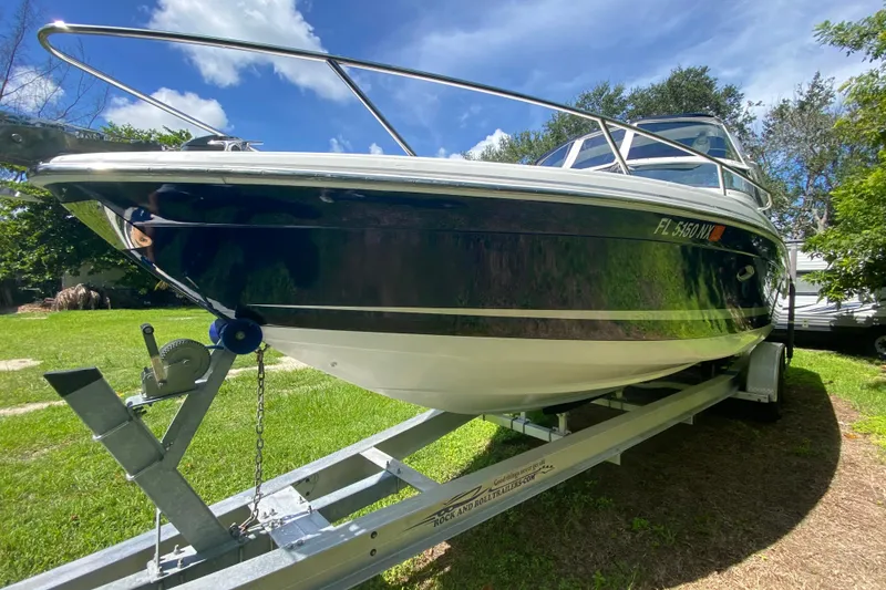 Slide: The Image of 2005 Formula 280 Sun Sport boat on trailer, parked on grass under blue sky. - 2