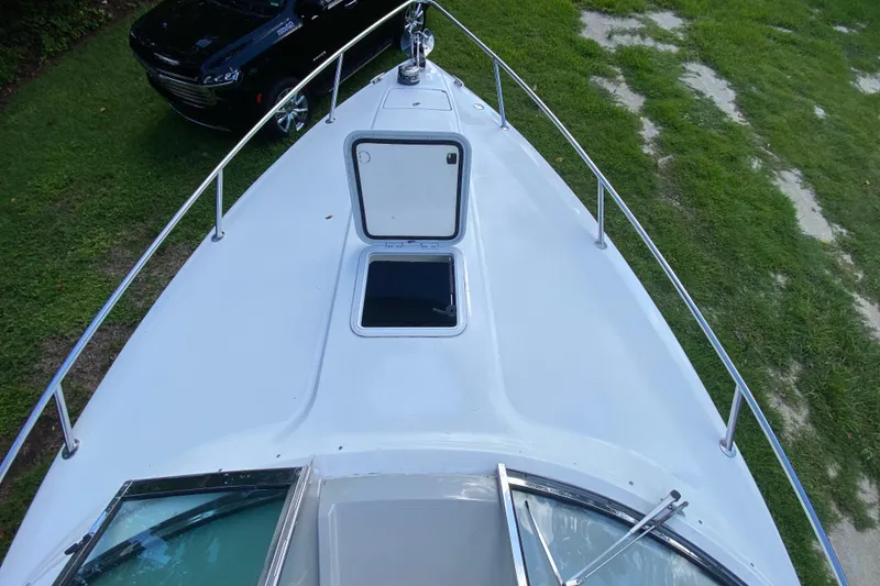 Slide: The Image of 2005 Formula 280 Sun Sport boat deck with open hatch, parked on grass. - 22
