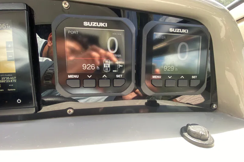 Slide: The Image of Suzuki digital gauges on a 2005 Formula 280 Sun Sport boat dashboard. - 34