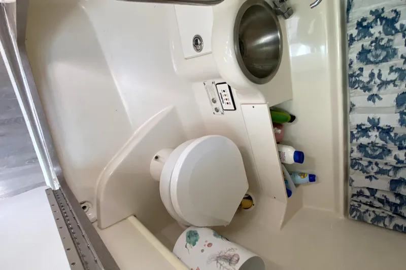 Slide: The Image of 2005 Formula 280 Sun Sport boat bathroom with sink, toilet, and toiletries. - 38