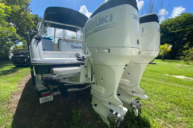 Slide: The Image of 2005 Formula 280 Sun Sport boat with dual Suzuki outboard motors on grassy area. - 44