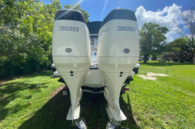 Slide: The Image of 2005 Formula 280 Sun Sport with twin 300 horsepower outboard engines, parked on grass. - 47