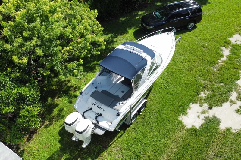 Slide: The Image of Aerial view of 2005 Formula 280 Sun Sport boat on grass beside a black SUV. - 49
