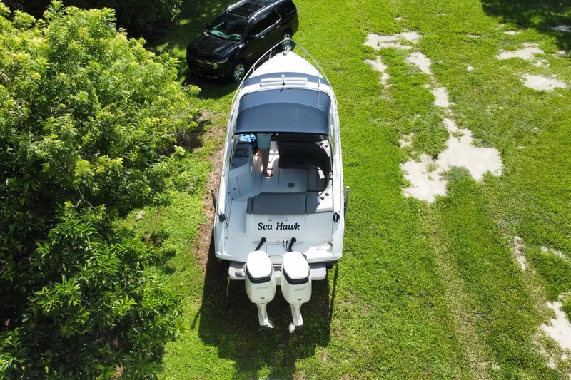 Slide: The Image of Overhead view of 2005 Formula 280 Sun Sport boat on grass, near a black SUV. - 50