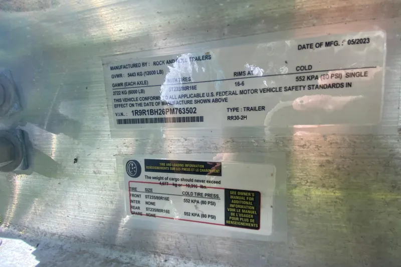 Slide: The Image of Close-up of a trailer information label with specifications and safety standards. - 59