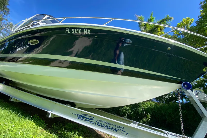 Slide: The Image of 2005 Formula 280 Sun Sport boat on trailer, vibrant blue sky background. - 6