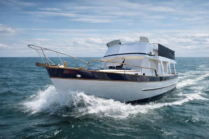 The Image of 1978 Marine Trader Europa yacht cruising on open sea under clear skies. - 0
