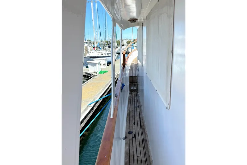 Slide: The Image of Side deck view of 1978 Marine Trader Europa yacht docked at marina. - 15