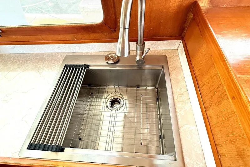 Slide: The Image of Stainless steel sink with modern faucet in 1978 Marine Trader Europa yacht kitchen. - 16