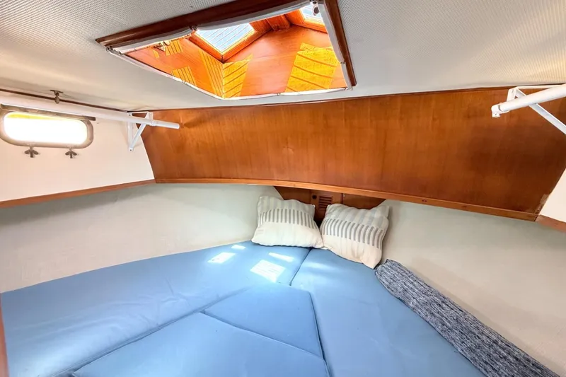 Slide: The Image of Cozy cabin interior of 1978 Marine Trader Europa with skylight and cushions. - 27