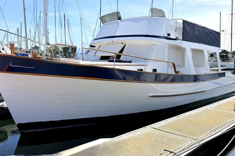 Slide: The Image of 1978 Marine Trader Europa yacht docked at marina, showcasing classic design and elegant lines. - 3