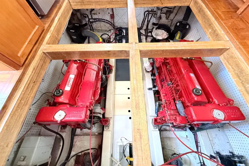 Slide: The Image of Engine room of a 1978 Marine Trader Europa with dual red diesel engines. - 31