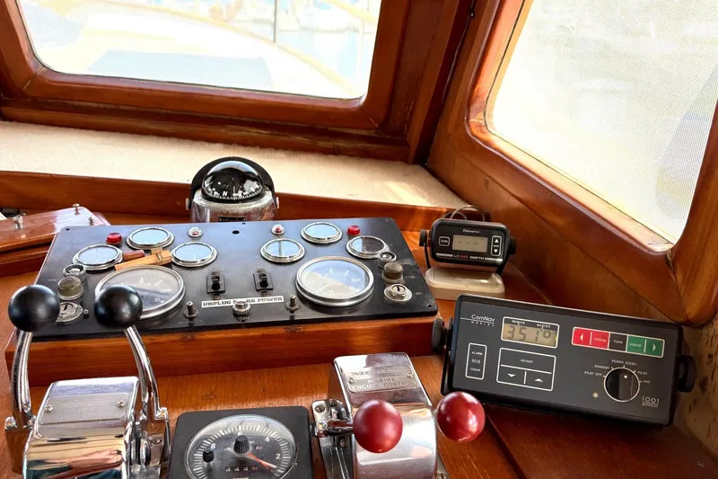 Slide: The Image of 1978 Marine Trader Europa helm with gauges, controls, and navigation equipment. - 4