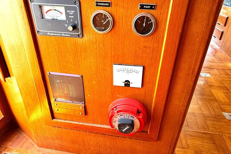 Slide: The Image of Control panel of a 1978 Marine Trader Europa boat with gauges and switches. - 6