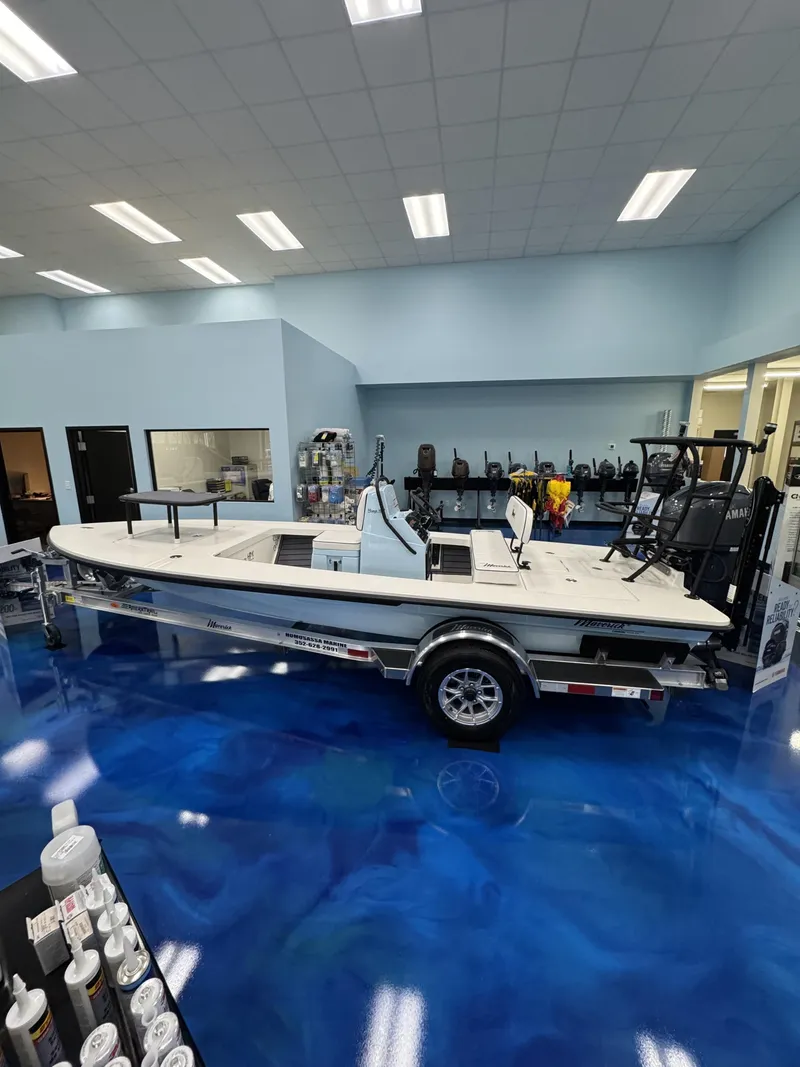 Slide: The Image of Maverick HPX-S 2026 boat displayed in showroom on blue floor. - 8
