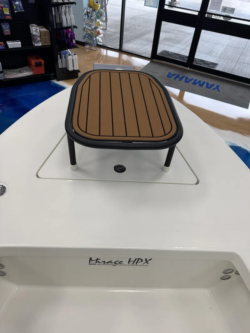 Slide: The Image of Maverick HPX-V 2026 boat with wooden table in showroom. - 22