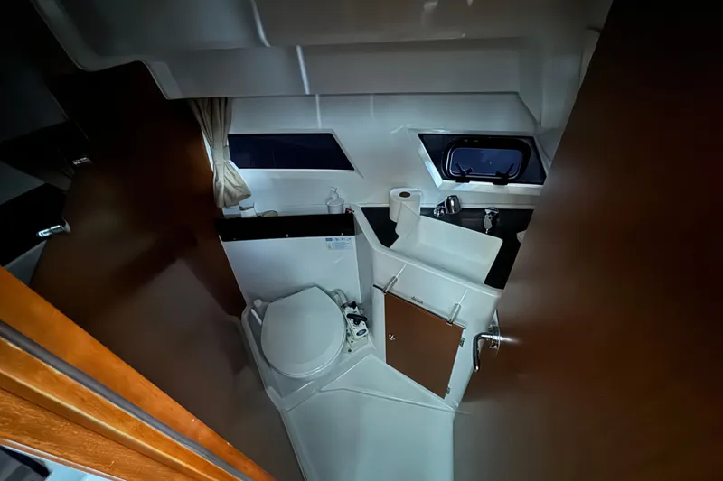 Slide: The Image of Compact bathroom in 2016 Jeanneau Merry Fisher 855 boat, featuring toilet and sink. - 14