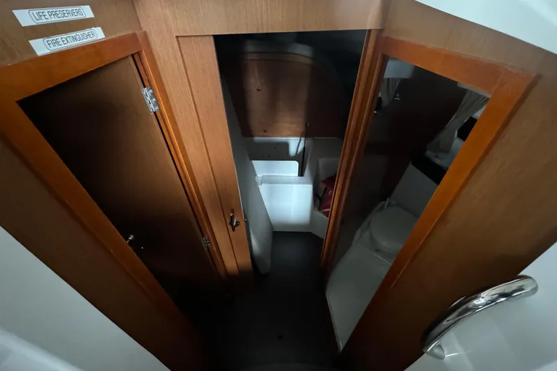 Slide: The Image of Interior of 2016 Jeanneau Merry Fisher 855 boat, featuring wooden doors and compact bathroom. - 17