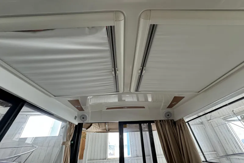 Slide: The Image of Interior view of 2016 Jeanneau Merry Fisher 855 with sunroof and curtains. - 18