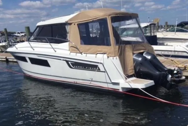 Slide: The Image of 2016 Jeanneau Merry Fisher 855 boat docked in a marina under a clear sky. - 8
