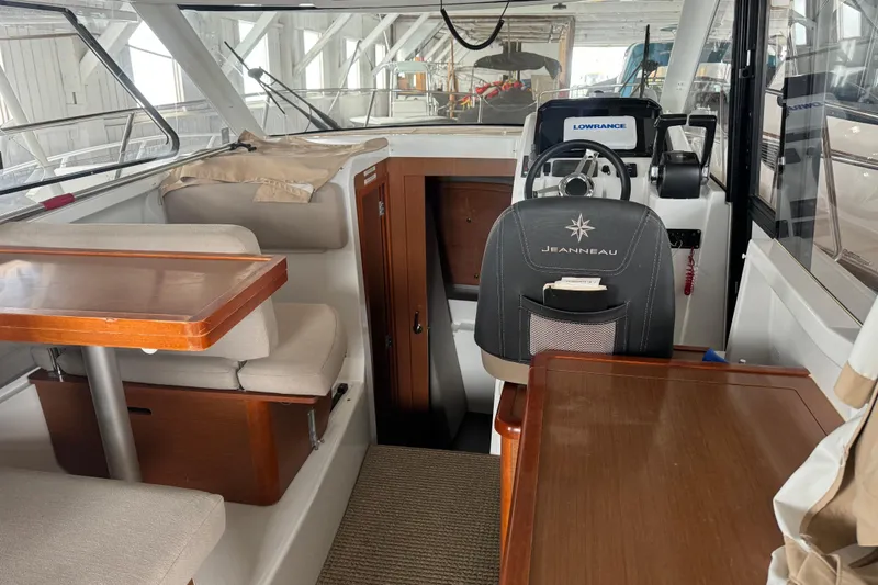 Slide: The Image of Interior of 2016 Jeanneau Merry Fisher 855 boat with seating and helm station. - 9