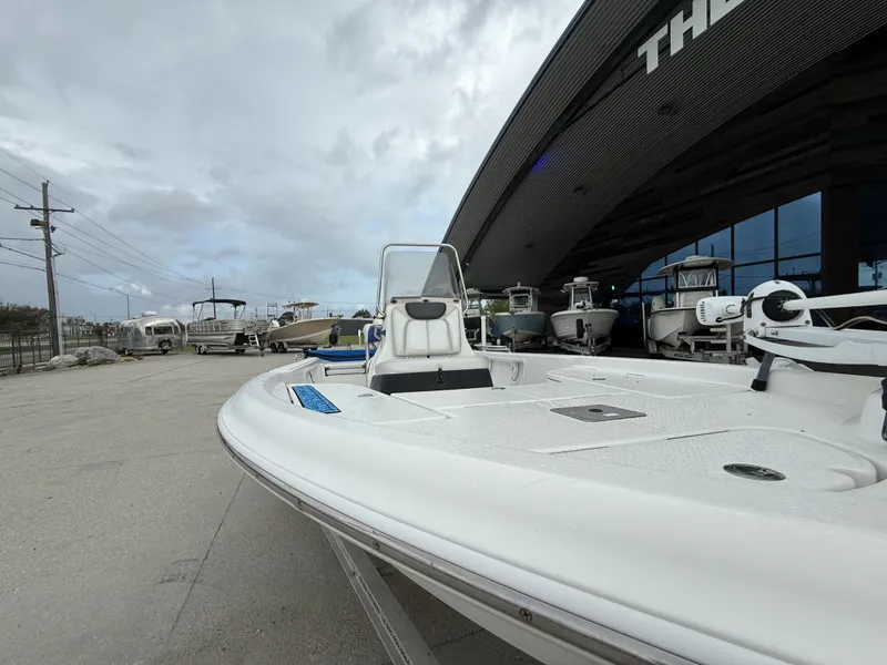 Slide: The Image of 2015 Blue Wave 2000 PureBay boat outside a showroom. - 15