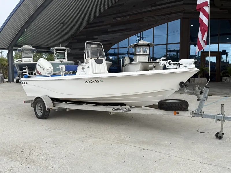 Slide: The Image of 2015 Blue Wave 2000 PureBay boat on trailer outside building. - 3