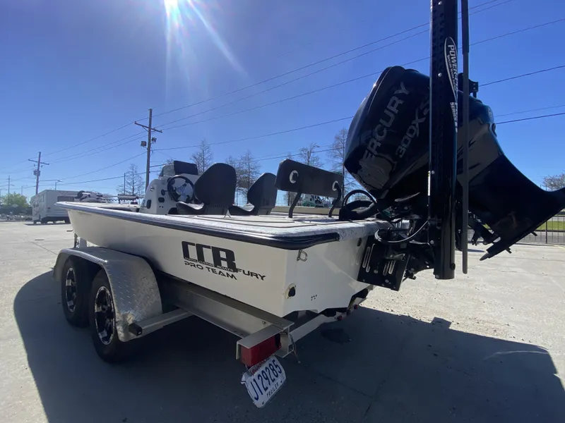 Slide: The Image of 2020 CCB 23' Fury boat with Mercury engine outdoors. - 3