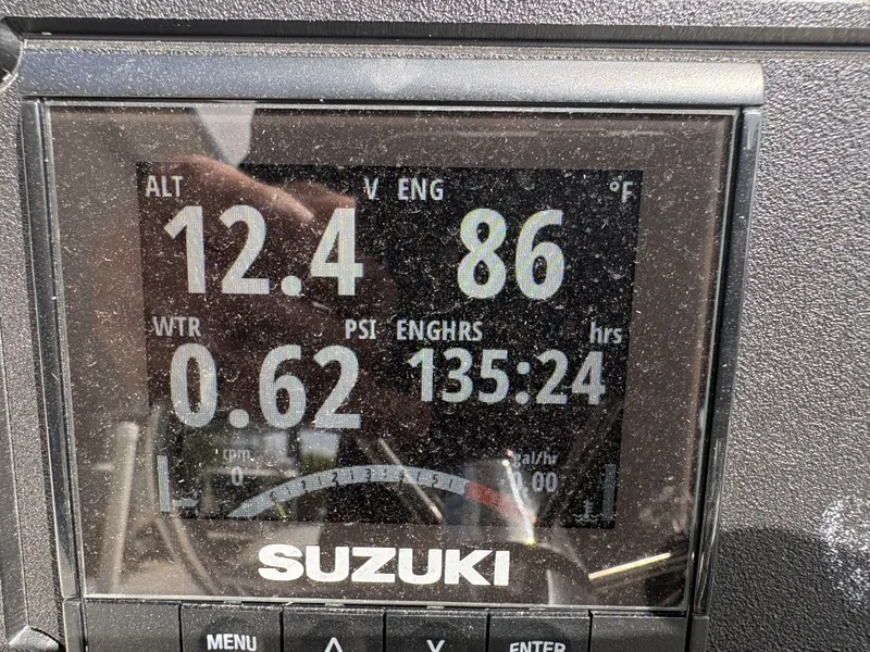 Slide: The Image of Suzuki engine display showing 135 hours, 12.4 volts, 86°F. - 18