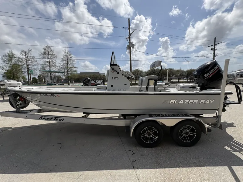 Slide: The Image of 2020 Blazer Bay 2170 boat on trailer under blue sky. - 3
