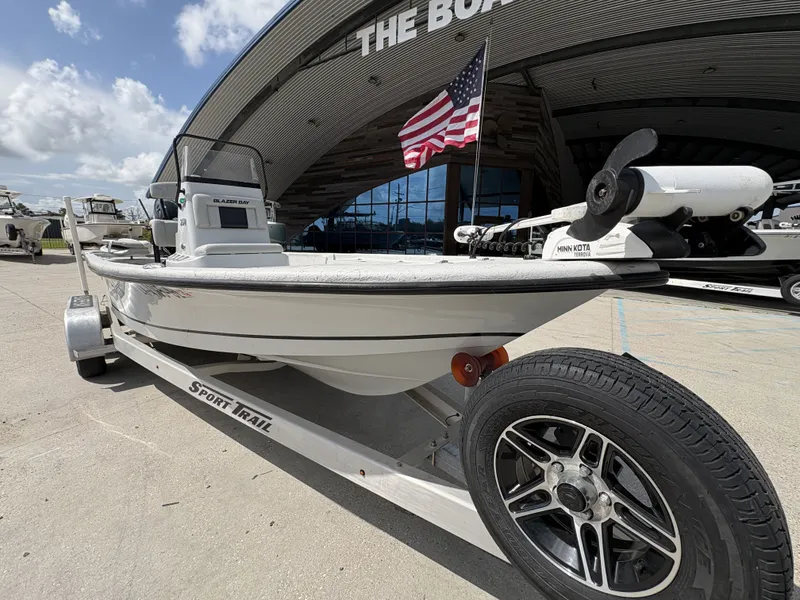 Slide: The Image of 2020 Blazer Bay 2170 boat on trailer in front of a building. - 6