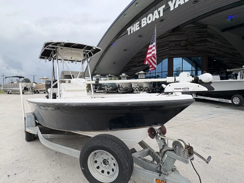 Slide: The Image of 2000 Kenner 21 CC boat at boatyard with American flag. - 18