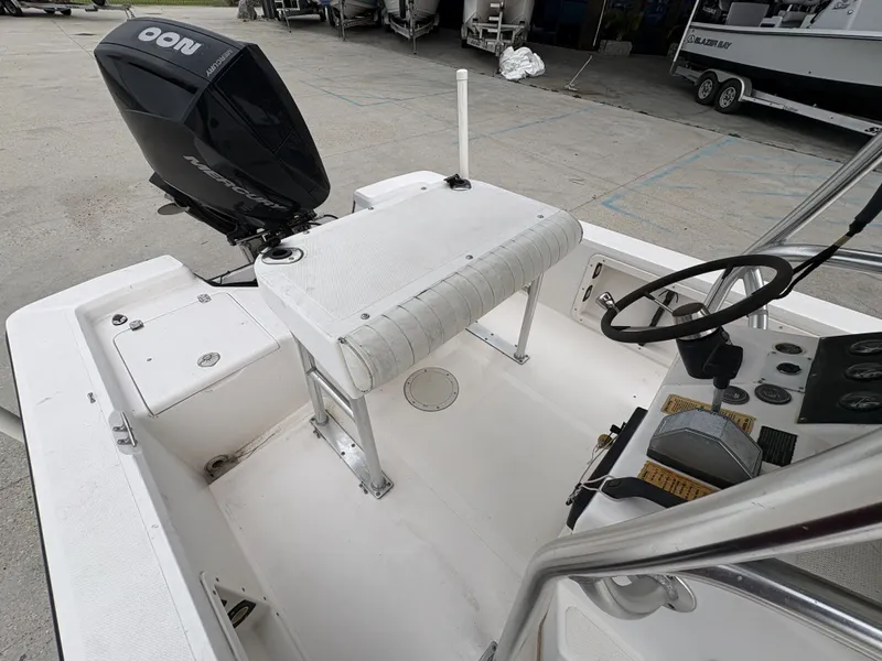 Slide: The Image of Interior view of a 2000 Kenner 21 CC boat with steering console. - 21