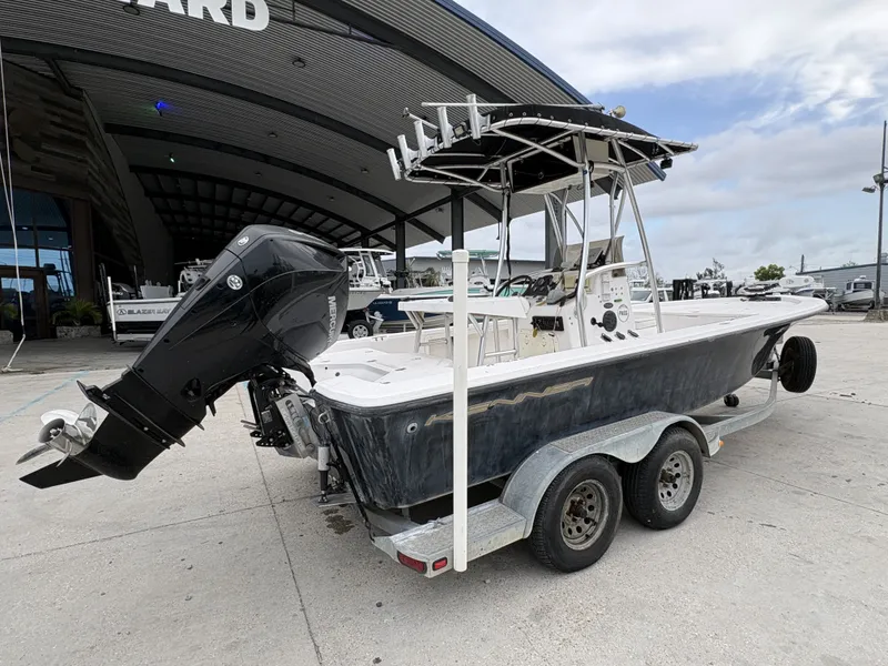 Slide: The Image of 2000 Kenner 21 CC boat on trailer outside shipyard. - 3