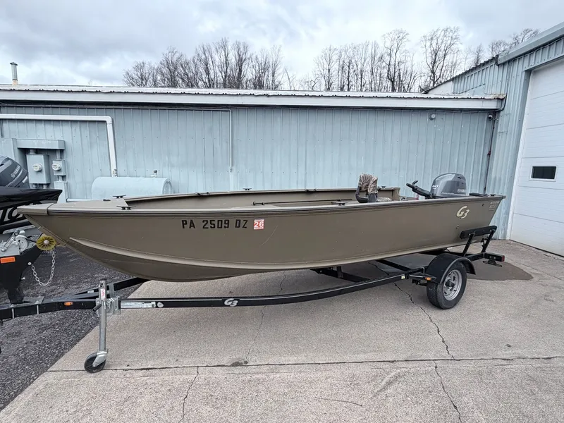 Slide: The Image of 2020 G3 Outfitter V177 T boat on trailer outside warehouse. - 24