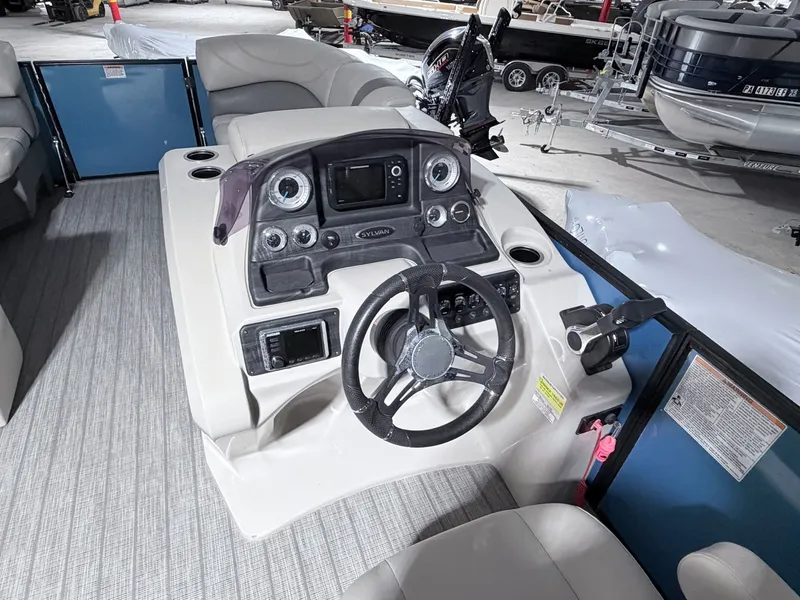 Slide: The Image of Interior view of a 2018 Sylvan 8522 LZ LES boat cockpit. - 11