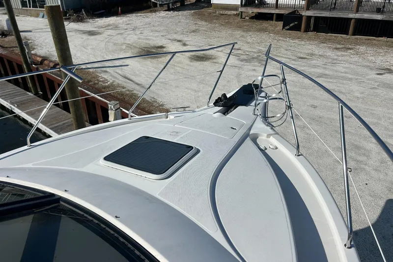 Slide: The Image of 2003 Silverton 330 Sport Bridge boat deck with railing, docked at marina. - 5