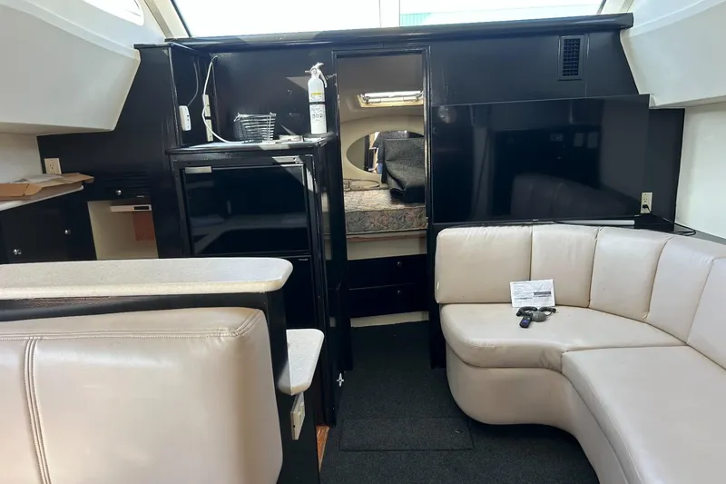 Slide: The Image of Interior of 2003 Silverton 330 Sport Bridge with beige seating and modern amenities. - 8