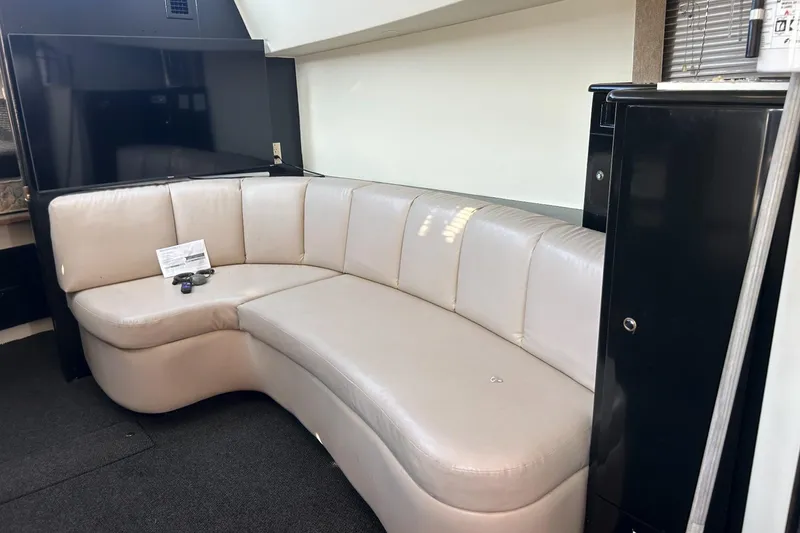Slide: The Image of Luxurious interior of 2003 Silverton 330 Sport Bridge with curved leather seating. - 9