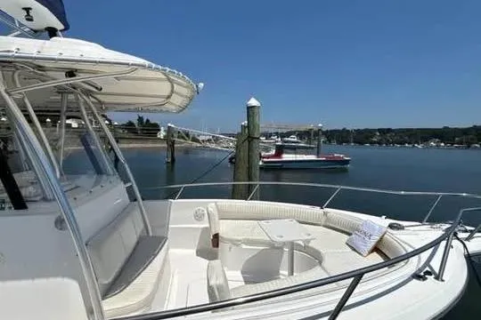 Slide: The Image of 2005 Stamas 310 Tarpon boat docked in a serene marina setting. - 12